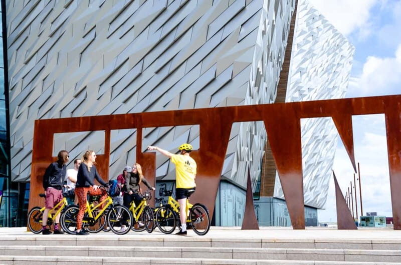 Belfast: City Highlights Bike Tour - The Peace Wall: writing on it turns a stop into a moment