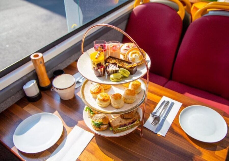 London: Afternoon Tea Bus with a Glass of Prosecco - Golden Tours Stop 1: board the pink-striped double-decker